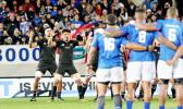 With Samoa flags to their back, the NZ All Blacks respond to Samoa's Siva Tau with their legendary Haka.  The New Zealand All Blacks defeated Manu Samoa 15s 78-0 at Eden Park, Auckland, New Zealand.   [Photo: Barry Markowitz]