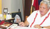 Prime Minister Tuilaepa Lupesoliai Sailele Malielegaoi displays the new book, Palemia Memoirs.  [courtesy photo M.P.M.C. Press Secretary]