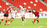USA scoring star, Perry Baker, demonstrates his Heisman Trophy form enroute to a try as the USA Eagles devastated Wales 35-19 at the Singapore Sevens, Day 1, National Stadium, Singapore.  [Photo: Barry Markowitz]