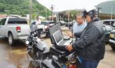 WELCOME TO THE 21ST CENTURY: Police senior officer, Lomu Mosese (left), demonstrated yesterday for a motorist, the Department of Public Safety’s new “electronic citation” or e-Ticket system, in which a police officer uses a laptop to issue a traffic violation ticket to a driver and the citation is automatically transmitted to the District Court. [photo: AF]