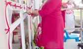 First lady Cynthia Malala Moliga cuts the ribbon during yesterday’s official dedication and opening of the new building in Tafuna for the Red Cross of American Samoa. See story inside. [photo: Leua Aiono Frost]