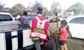 Local American Red Cross Disaster Team member Fa’asaei Davenport speaking with members of a family in Ili’ili, who lost their home in an Aug. 28 fire. Remnants of the burnt home are seen behind the family members. Five different fires displaced 5 families — with their homes a total loss, during the last week of August. The Red Cross depends on public donations from the community to help those in need; and Red Cross donation boxes can be found on the check out counters of many retail stores in the territory.
