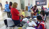 American Red Cross officials and volunteers from the US working with local Red Cross volunteers yesterday at the Tafuna office, before disaster teams head out to the field. [photo: Leua Aiono Frost]