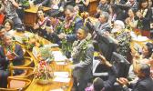 Hawai’i state Rep. Cedric Solosolo Asuega Gates (standing-front) being recognized along with another lawmaker, on the floor of the Hawai’i state House of Representatives on Jan. 18 — the opening of the Hawai’i Legislature. Family members of lawmakers were also on the floor behind them.  [photo: Rep. Gates Office]