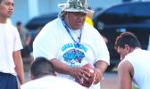Samoana Sharks Defensive Coordinator, Maselino Tautu keeping a close eye on his defensive unit during practice yesterday evening at their school field. [photo: TG]