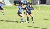 A Samoana player, left, and SPA opponent battle for possession of the ball during a 2016-17 ASHSAA Girls soccer game on Wednesday March 8, 2017 at Pago Park Soccer Stadium.   [FFAS MEDIA/Brian Vitolio]
