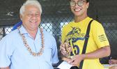 Sam Tualaulelei, a Pago Youth defender, receives his MVP trophy from FFAS President Faiivae Iuli Alex Godinet, left, for the 2016 FFAS National League on Saturday, November 26, 2016.   [FFAS MEDIA/Brian Vitolio]