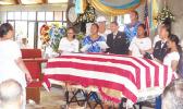 The United States flag draped casket of the late former Sen. Fuata Dr. Tagiilima I’atala, during his memorial service on Sunday at the CCCAS church in Amouli, with his children and his wife, Manumanu Sipili I’atala  (in white and wearing a hat — far left). [photo: Samoa News]