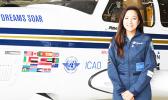 This 2017 photo provided by the non-profit group Dreams Soar, shows female aviator, Shaesta Waiz, with her Dreams Soar single engine Beechcraft Bonanza A36 plane. Waiz began her global solo flight in May this year from Dayton, Florida. She landed at Pago Pago International Airport last Friday afternoon for a two-day stop over to refuel and rest before departing yesterday. On the plane’s body are flags of some of the countries and territories where she made  stops, including the American Samoa Flag — shown o