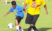 Aaron Singh, left, of the Fa’asao-Marist Crusaders dribbles the ball against a Tafuna Warriors opponent during an ASHSAA Boys J-V Soccer game on Monday, April 2, 2018 at Pago Park Soccer Stadium.  [FFAS MEDIA/Brian Vitolio]