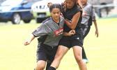 A Royal Puma player attempts a tackle against a Taputimu Youth opponent in a Match Day 7 game of the women’s 2017 FFAS National League at Pago Park Soccer Stadium on Saturday, October 28, 2017.  [FFAS MEDIA/Brian Vitolio]