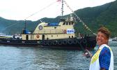 Port Administration director, Taimalelagi Dr. Claire Poumele, posed for a Samoa News photo on the main dock yesterday with Port’s second tugboat, Peggy H, in the waters of Pago Pago Harbor.  The tugboat, will be renamed Iseula and is the second one for the Port Administration as required by US Coast Guard regulations.  [photo: Leua Aiono Frost]