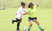 A Vaiala Tongan player (left) and Lion Heart opponent fight for possession of the ball during a women’s game on Match Day 5 of the 2016 FFAS National League on Saturday, Sept. 17, at Pago Park Soccer Stadium.  [FFAS MEDIA/Brian Vitolio] 
