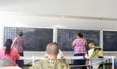 Two Election Office personnel on the chalkboard marking off one-by-one each ballot called out by a senior election official during the counting yesterday of the gubernatorial race absentee ballot at the Election Office.  [photo: FS]