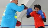 Trainer, Sala Senele Etuale hitting the pad with one of the local boxers 