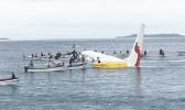In this Sept. 28, 2018, file photo, local fishing boats move in to recover the passengers and crew of Air Niugini flight following the plane crashing into the sea on its approach to Chuuk International Airport in the Federated States of Micronesia. The airline operating a flight that crashed into a Pacific lagoon on Friday in Micronesia now says that one man is missing, after earlier saying that all 47 passengers and crew had safely evacuated the sinking plane. (James Yaingeluo via AP, File) local fishing boats move in to recover the passengers and crew of Air Niugini flight