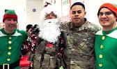 Senior Airman Oto with Santa and his elves