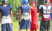 All-Star Linebacker coach Merton Hunkin of Faga’itua High School working with his backs, during practice this past Tuesday. [photo: TG]