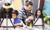 Artist Lureen Cascara helps Koa Kaeka Baptista, 9, with his painting while Michelle Florido helps her son Tristan, 3, and Corinne Ebias, 9, with their painting during the Aloha Festival at the Napa Valley Expo on Saturday. [Maria Sestet, Napa Valley Register]