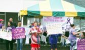 Amata and other rally participants holding signs
