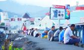 Samoa residents sit along the seawall in downtown Apia