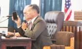 Homeland Security director Samana Semo Ve’ave’a holds up an iPhone
