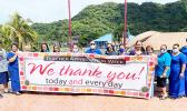 DOE admin holding up Teacher Appreciation Week banner