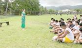 Marian McGuire Ale speaking to Leone football players 