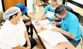 Two employees with Joseph Felise (right, at back), Solefai Tapuala (right, front) at the StarKist HR Office