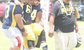 An injured Nu’uuli Wildcat offensive lineman is carried off the field by his teammates, a protocol established by ATC Florence Wasko throughout the season.  [photo: TG]