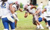 Tala Sufia is sacked by Fa’avae of the Sharks behind the line of scrimmage for a loss. Fa’avae led the Sharks in shutting out the Warriors in the opening quarter of last Saturday's championship game. [photo: TG]