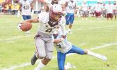 Paea Latu of the Warriors trying to break a tackle by Elliot Lelei during their varsity title game last Saturday morning, where the Warriors lost to Samoana 6-7. [photo: TG]