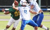 Anthony Feala of the Sharks, flexing to pass to Elliot Lelei for another touchdown conversion in the second quarter of their varsity game against the Lions last Saturday afternoon. Feala led the Sharks in a dominating 34-8 victory.  [photo: TG]