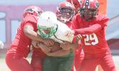 Leone’s quarterback getting sacked in the back field by three Viking defenders in the opening quarter of a JV game last Saturday.  [photo: TG]