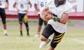 Nu’uuli Wildcats quarterback, Daniel Maea scrambling out with the ball and opting to keep it on a play-action pass play against the Vikings last Friday evening at the Veterans Memorial Stadium. [photo: TG]