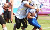 Koa Leama of Nu’uuli devoured John Uga’itafa behind the line of scrimmage for a huge loss on a quick receiver pass play. Leama read this one, and came in for the stop in the second quarter of their JV game last Saturday morning.  [photo: TG]