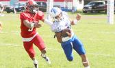 Paul Fano — who helped Samoana’s JV team to a ‘Back-2-Back’ Championship title this year — was moved up to the varsity level last Saturday, and carried the load for the Sharks as the Blue Empire opted to give Moses Michael Samia a break, and easing off Lewis Malala Jr., two of their best ball carriers this year. Fano is pictured trying to evade a tackle by Vikings senior safety, Aroni Taua’a. [photo: TG]