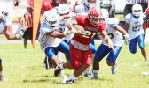 The hardest working Viking last Saturday was Pitonu’u Ah-Sue – seen here refusing to go down. Ah-Sue, known as one of the most relentless runners in the league, led the Varsity Vikings to a 30-14 victory in their senior game against the Samoana Sharks. [photo: TG]