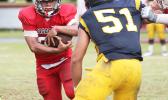 Faga'itua's Advent Migi carrying the ball and staring down Dennis Enoka from Nu’uuli before a collision at the line of scrimmage during the second half of their Varsity match up this past Saturday morning at the Veterans Memorial Stadium. Migi helped the Vikings win 53-0. [photo: TG]