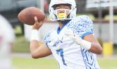 Jr. ‘Jam’ Tanielu of Samoana looking downfield and charging up to fire a long one to his receiver. Samoana blew out Tafuna 46-8 in JV competition. [photo: TG]