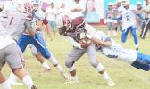 Tafuna’s kick off returner was immediately apprehended in the backfield by a Samoana Shark, during the opening quarter of a Junior Varsity match up last Saturday morning.  [photo: TG]