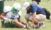 ASHSAA ATC Florence Wasko tending to an injured Leone Lion, during the second quarter of a Junior Varsity game against the Warriors last Saturday morning. Tafuna won 34-22. [photo: TG]