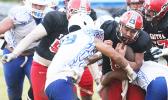 Vikings quarterback, Vito Kitiona was devoured by the Sharks defensive unit during the opening half of their Varsity match up last Friday evening at the Veterans Memorial Stadium – the Samoana Sharks defeated the Vikes 14 - 12 — a stunning win. [photo: TG]