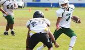 Leone Lions quarterback, Oakland Salave’a running downfield with a quarterback keeper for a huge gain for the Lions during the opening half of their Junior Varsity game against the Wildcats this past Saturday morning – the match was scoreless.  [photo: TG]
