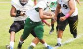 A Leone Lions tailback being apprehended and about to be tackled for a loss by the Wildcats defense during the second half of play of their Junior Varsity match up where both teams were scoreless last Saturday morning. [photo: TG]