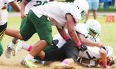 Nu’uuli Wildcats quarterback is immediately sacked hard in the backfield by Cyan Fiatoa during the final quarter of their scoreless JV game that was held this past Saturday morning at the Veterans Memorial Stadium.  [photo: TG]