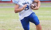 Louis Malala Jr. carrying the ball for the Samoana Sharks during the opening quarter of their varsity match up against the Lions last Thursday evening. Malala scored the opening touchdown of the game and the only offensive touchdown for Samoana, who beat Leone 14-0. [photo: TG]