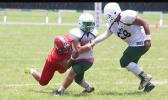 Ron Fuala’au of the Lions immediately stopped in the backfield by Jake Umu of the Vikings during the second half of their junior varsity match up last Saturday morning. Fuala’au helped the Lions to a 26-14 win, their first victory of the season. [photo: TG]
