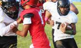 Nathaniel Maea of Nu’uuli with the quarterback keep trying to read his blockers downfield as he gained huge yardage for Nu’uuli on this one. Maea helped the JV Wildcats to their first victory of the season, a 14-6 win over Faga’itua.  [photo: TG]