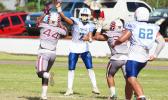 Jr. Tanielu releasing a screen pass just seconds before getting sandwiched by two Tafuna defenders, during their JV match up last Saturday morning. Tanielu led the Sharks in a 8-6 victory over the Warriors.  [photo: TG]